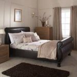 Larson Sleigh Bed In Brown Faux Leather With Wooden Legs